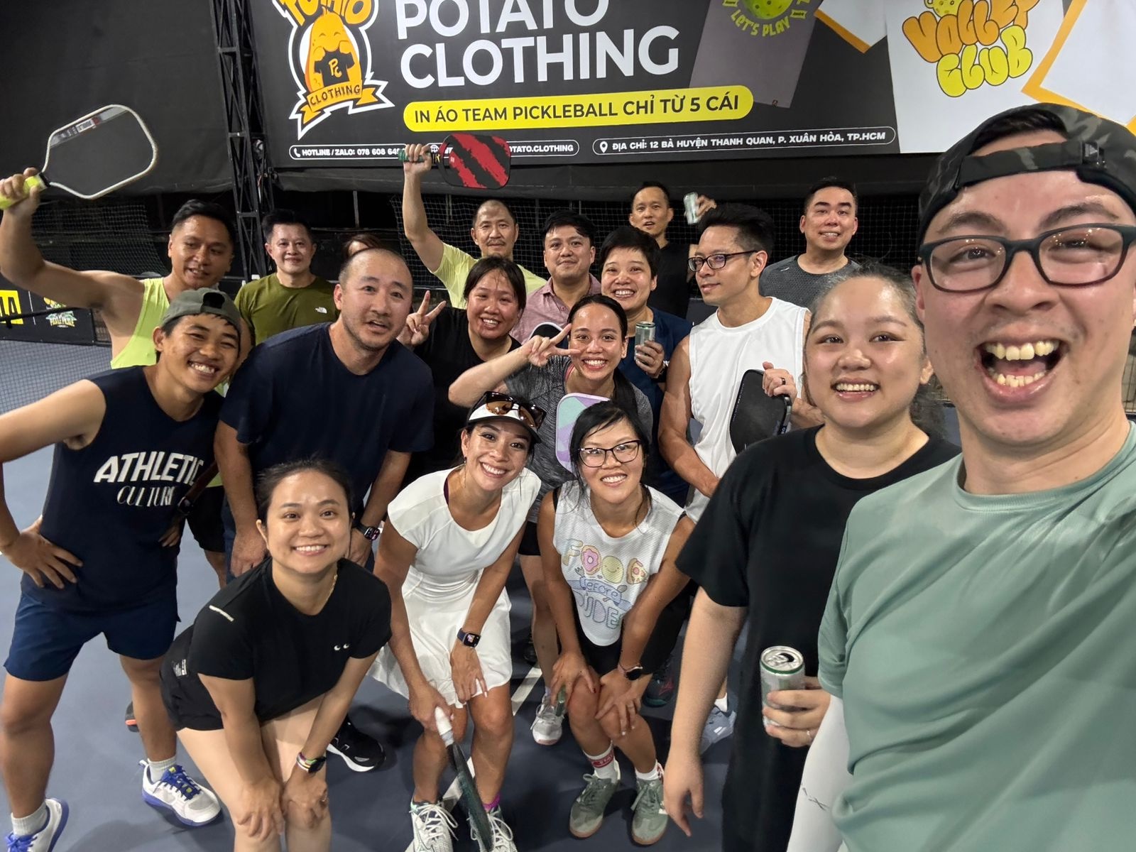 A group of pickleball players smiling together at a local social in Ho Chi Minh City
